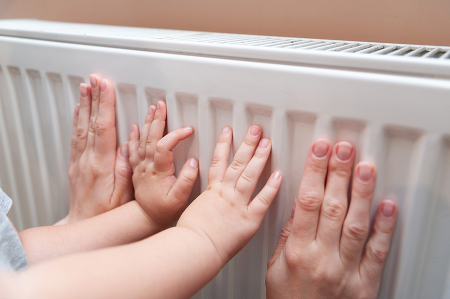 Deux paires de mains sur un radiateur